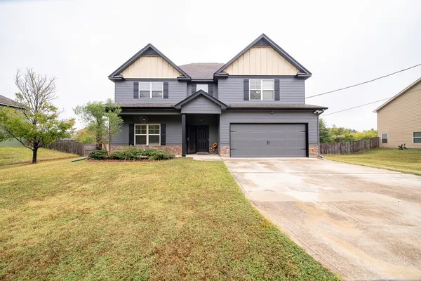a front view of a house with a yard
