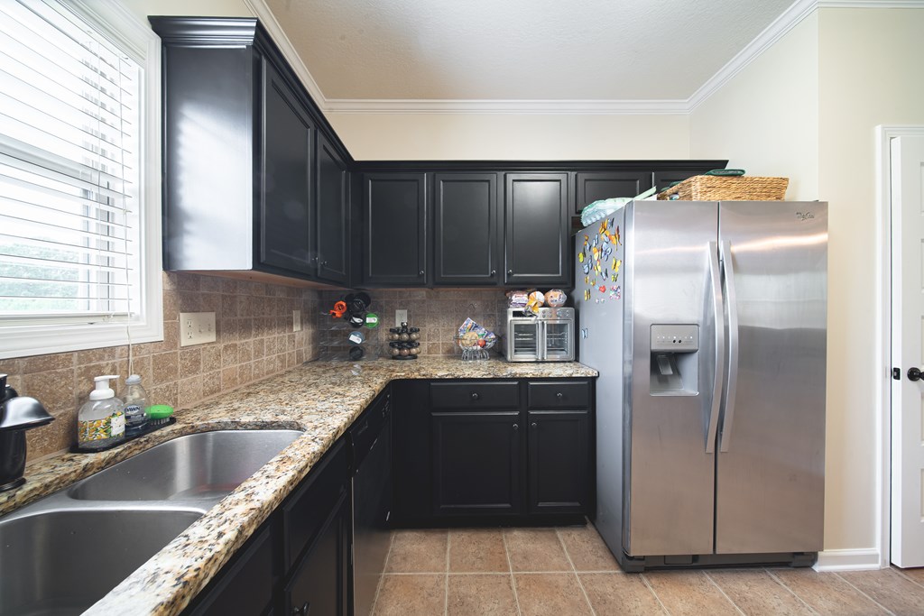 305 Owens Road Fort Mitchell, AL 36856 - Photo 15 of 44 a kitchen with granite countertop a refrigerator and a sink