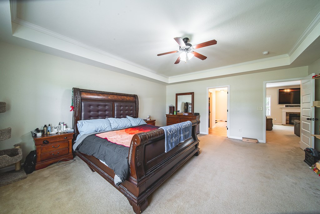 305 Owens Road Fort Mitchell, AL 36856 - Photo 17 of 44 a bedroom with a bed and a chandelier