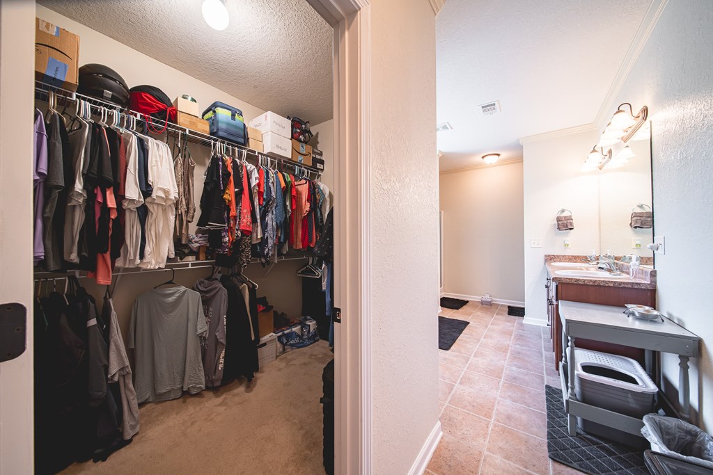 305 Owens Road Fort Mitchell, AL 36856 - Photo 18 of 44 a view of walk in closet with clothes and shoes