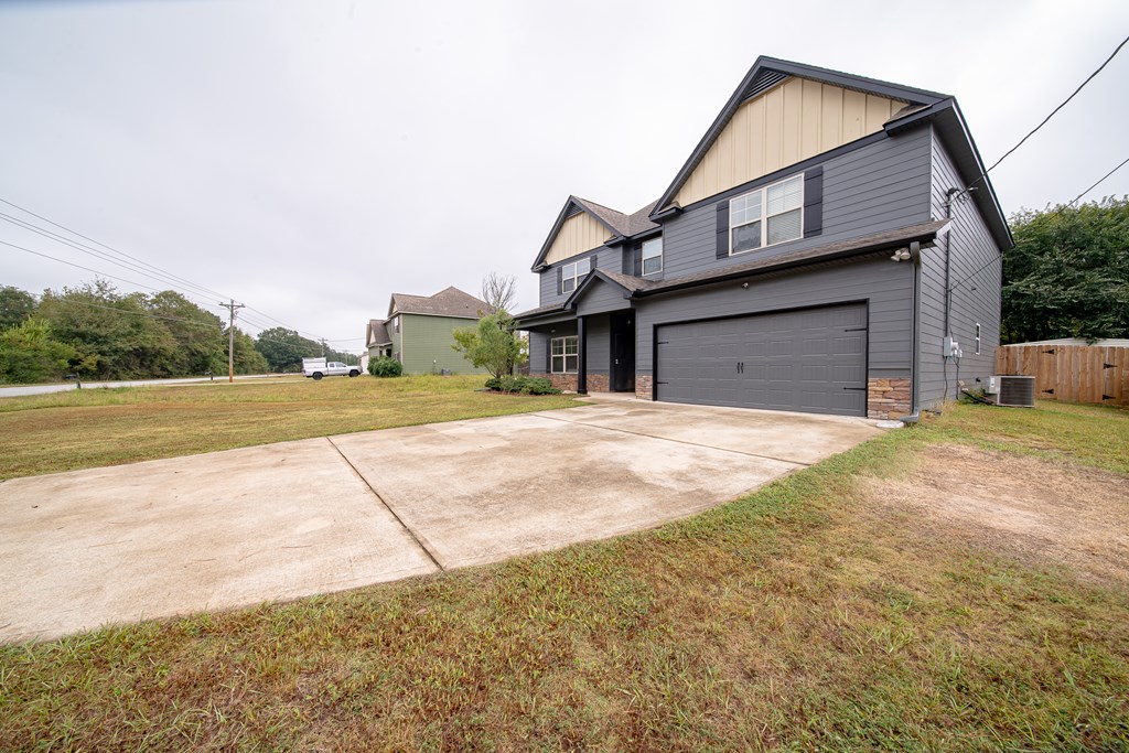 305 Owens Road Fort Mitchell, AL 36856 - Photo 2 of 44 a view of a house with a yard and garage
