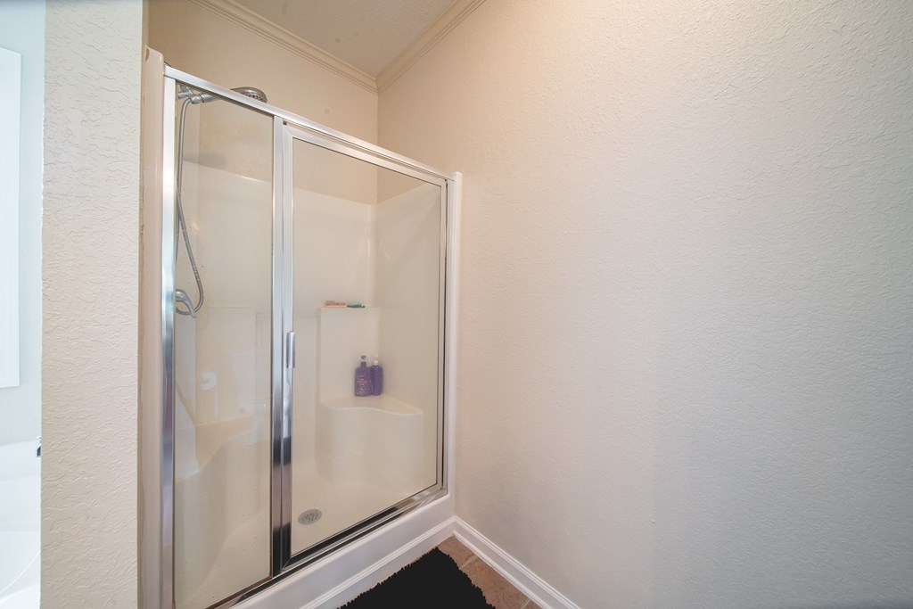 305 Owens Road Fort Mitchell, AL 36856 - Photo 22 of 44 a bathroom with a glass shower door