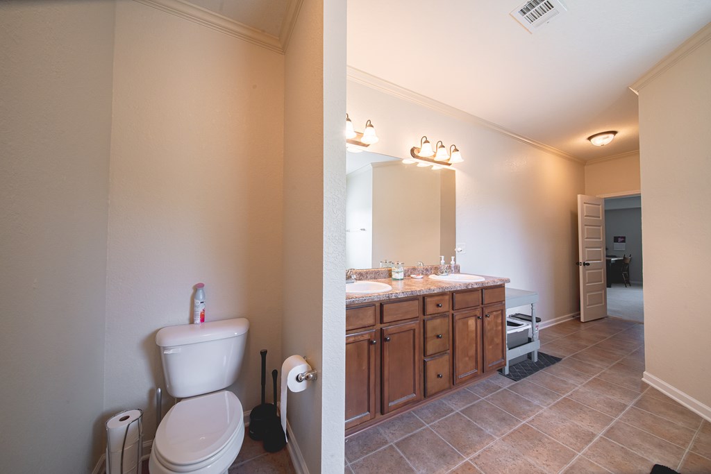 305 Owens Road Fort Mitchell, AL 36856 - Photo 23 of 44 a bathroom with a toilet a sink and mirror