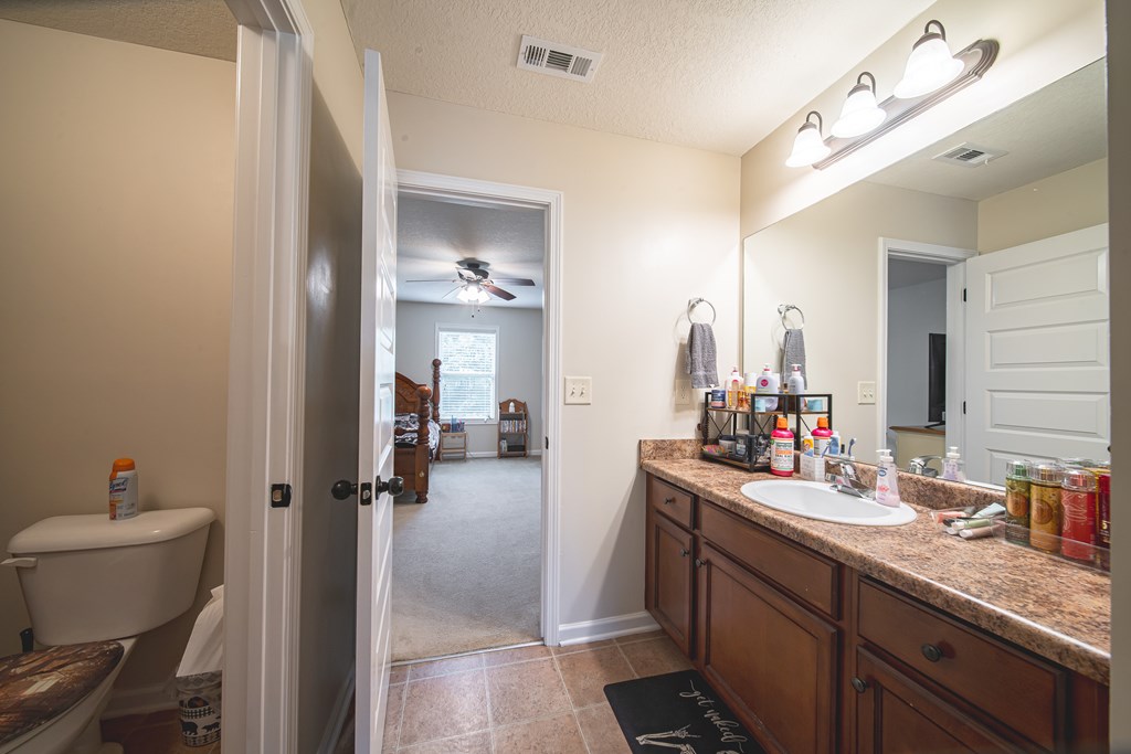 305 Owens Road Fort Mitchell, AL 36856 - Photo 27 of 44 a bathroom with a sink and mirror with toilet