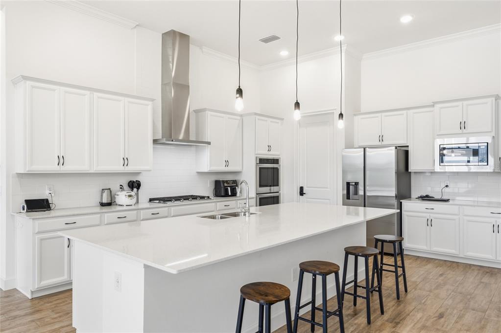 16071 Barkly Rdg Court Winter Garden, FL 34787 - Photo 12 of 31 a kitchen with stainless steel appliances a white table chairs and a refrigerator