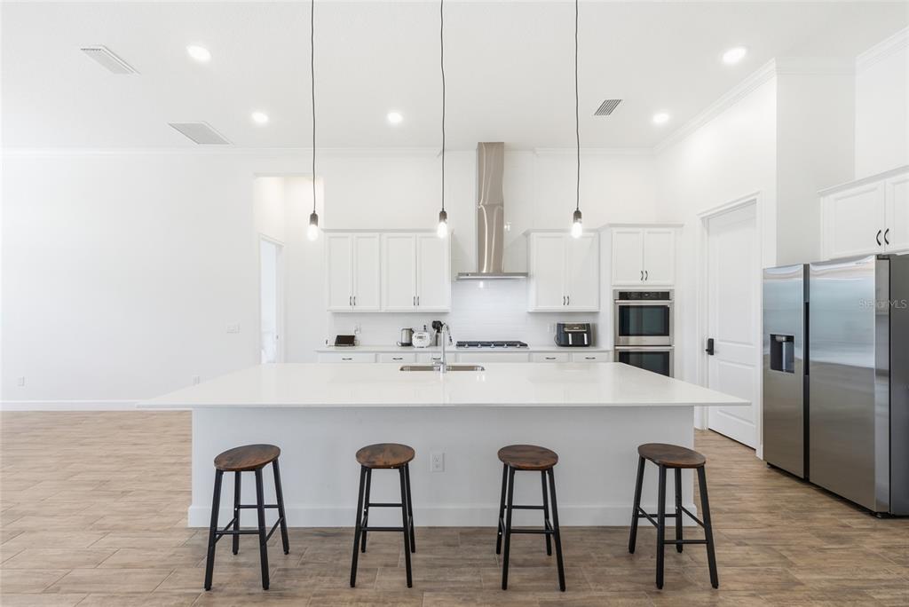 16071 Barkly Rdg Court Winter Garden, FL 34787 - Photo 13 of 31 a kitchen with stainless steel appliances a table chairs refrigerator and microwave