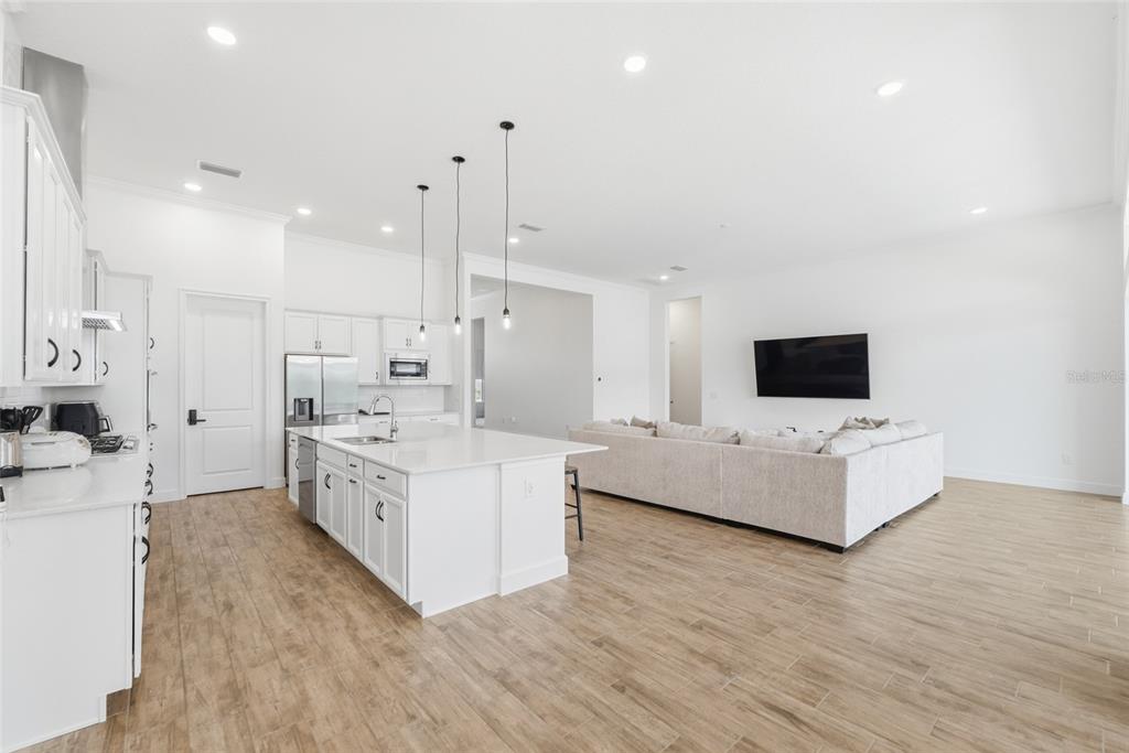 16071 Barkly Rdg Court Winter Garden, FL 34787 - Photo 16 of 31 a large white kitchen with a large counter top and stainless steel appliances