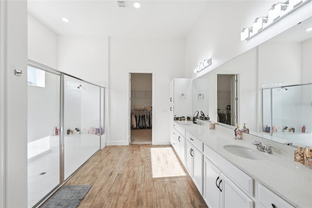16071 Barkly Rdg Court Winter Garden, FL 34787 - Photo 18 of 31 a spacious bathroom with a double vanity sink a mirror and a shower