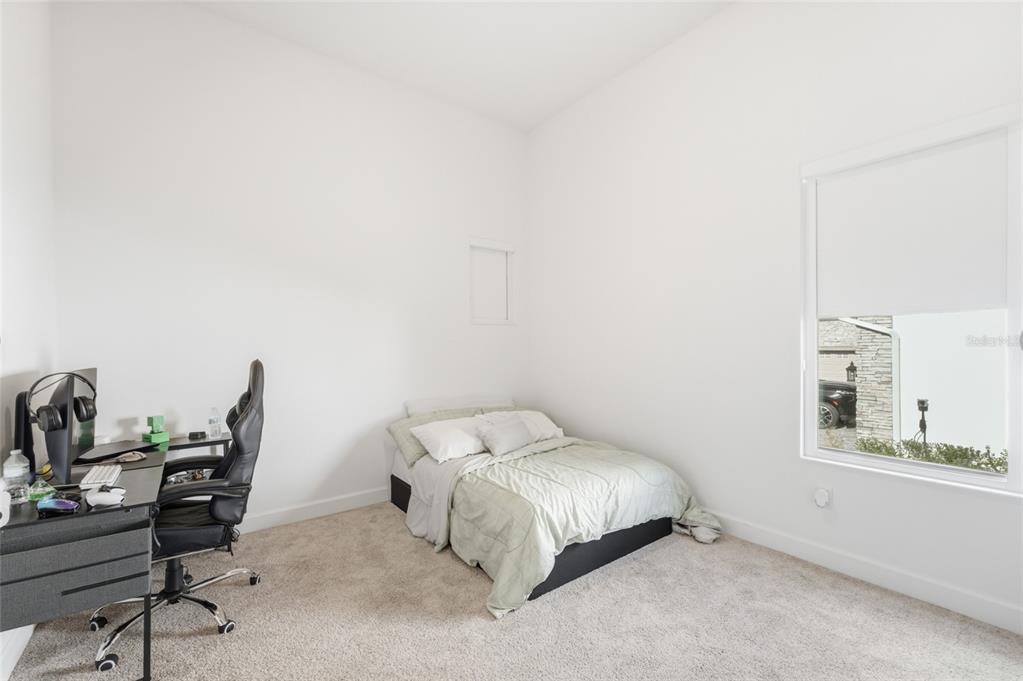 16071 Barkly Rdg Court Winter Garden, FL 34787 - Photo 21 of 31 a bedroom with a bed a table and chair