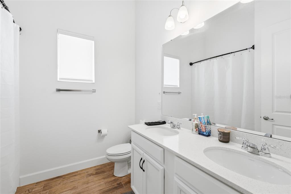 16071 Barkly Rdg Court Winter Garden, FL 34787 - Photo 22 of 31 a bathroom with a toilet a sink and mirror