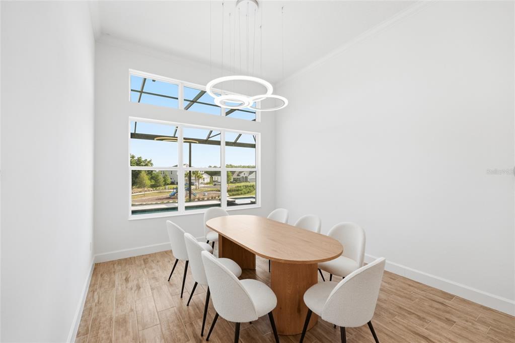 16071 Barkly Rdg Court Winter Garden, FL 34787 - Photo 10 of 31 a view of a dining room with furniture wooden floor and chandelier