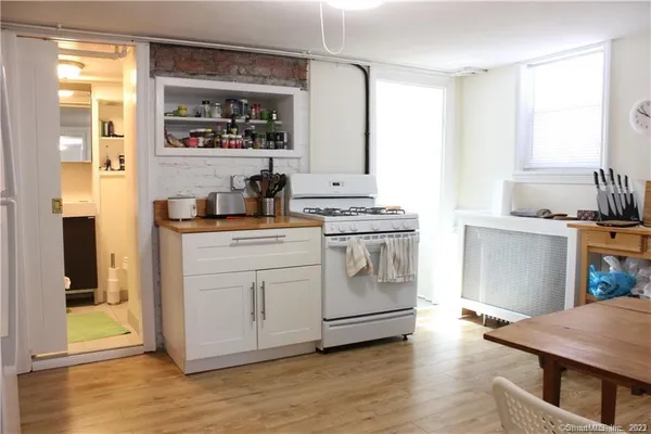 a kitchen with a stove a sink and a refrigerator