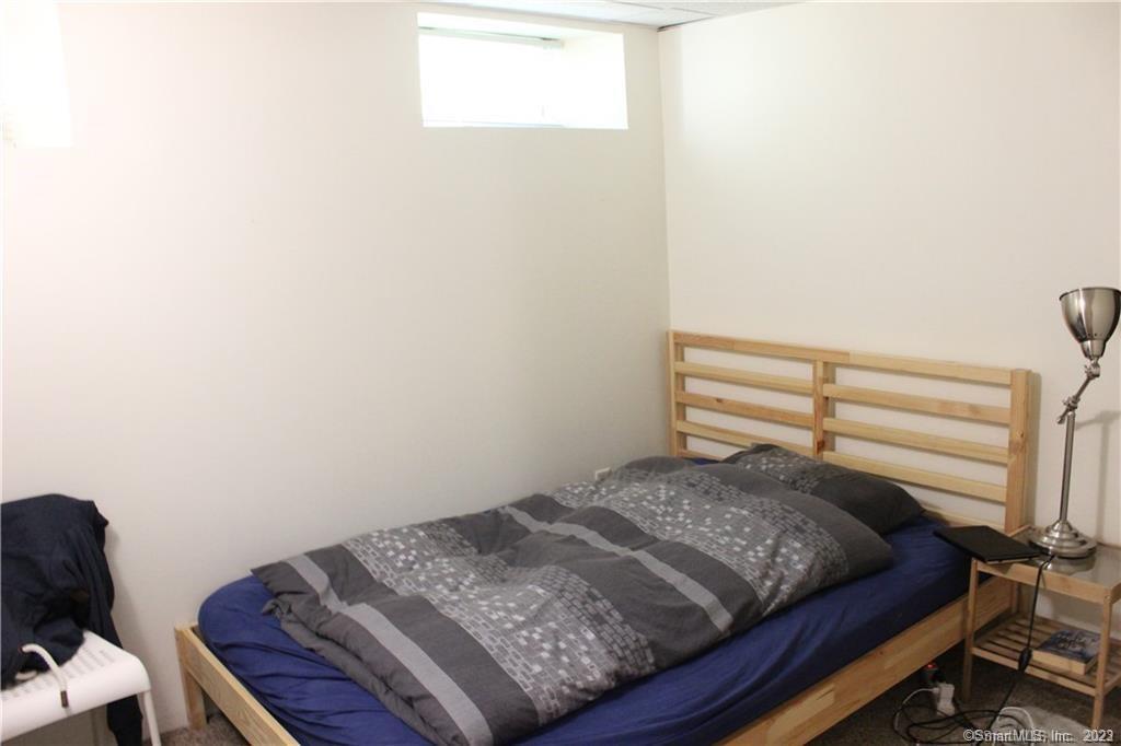 13 Pleasant Street, Unit LL New Haven, CT 06511 - Photo 7 of 8 a bedroom with a bed and a chair