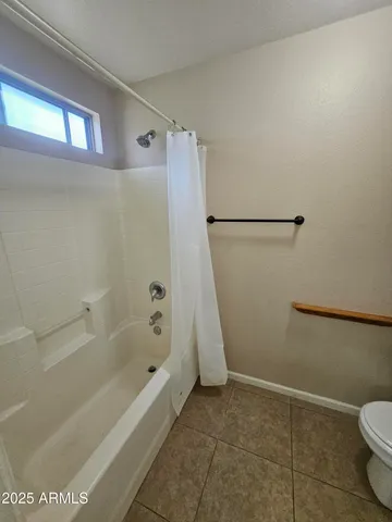 a bathroom with a bathtub and a toilet