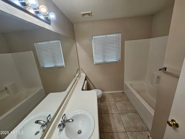a bathroom with a tub a sink and a shower