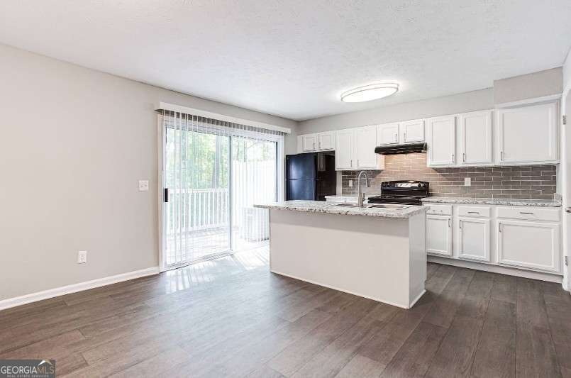 707 Franklin Road, Unit 1812 Marietta, GA 30067 - Photo 1 of 13 a kitchen with wooden floors white cabinets and window