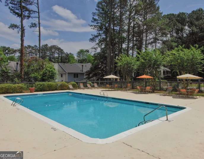 707 Franklin Road, Unit 1812 Marietta, GA 30067 - Photo 8 of 13 a view of a swimming pool with outdoor seating and plants