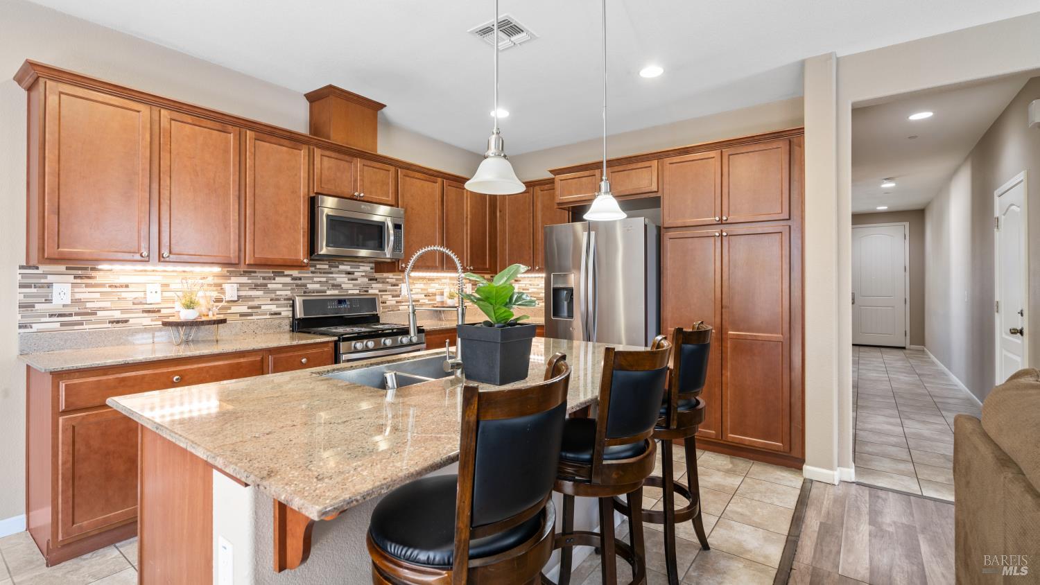524 Chaparral Loop Vacaville, CA 95688 - Photo 11 of 43 a kitchen with stainless steel appliances granite countertop sink refrigerator and microwave