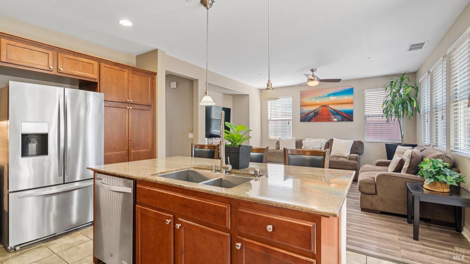 524 Chaparral Loop Vacaville, CA 95688 - Photo 14 of 43 a kitchen with stainless steel appliances granite countertop a refrigerator a sink a stove and a dining table with wooden floor