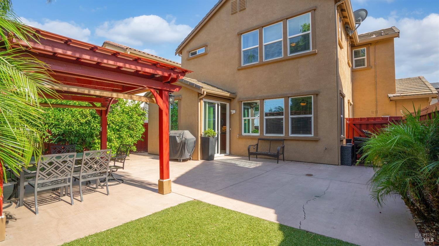 524 Chaparral Loop Vacaville, CA 95688 - Photo 28 of 43 a view of a patio with table and chairs potted plants and floor to ceiling window