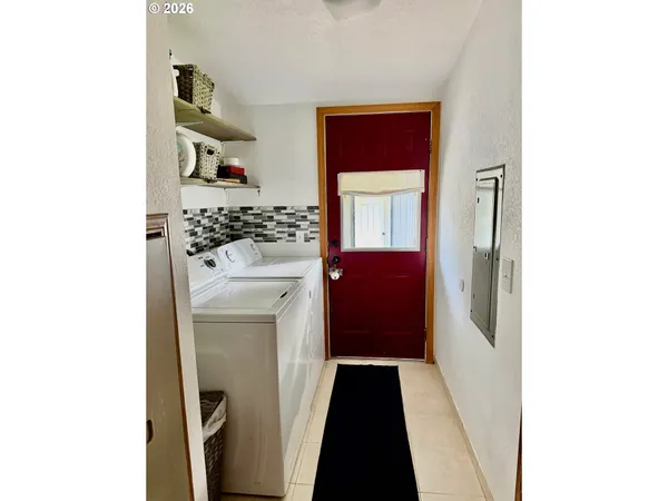 a kitchen with a refrigerator and a stove