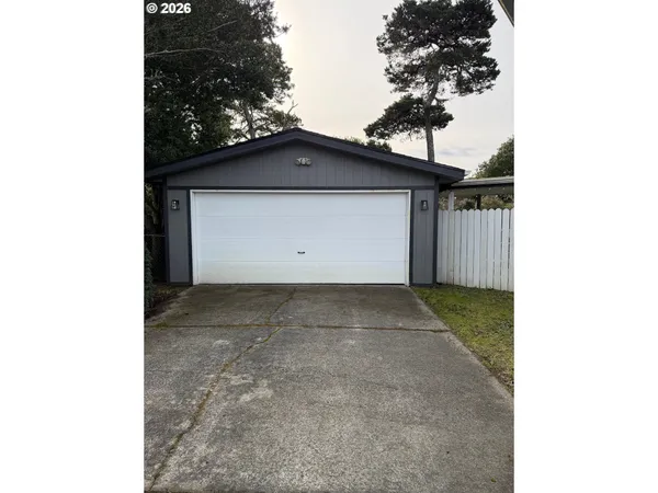 a view of garage and small yard