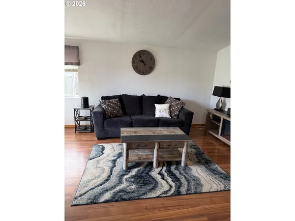 a living room with furniture and a rug