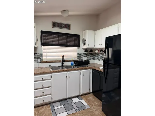 a kitchen with stainless steel appliances a sink and cabinets