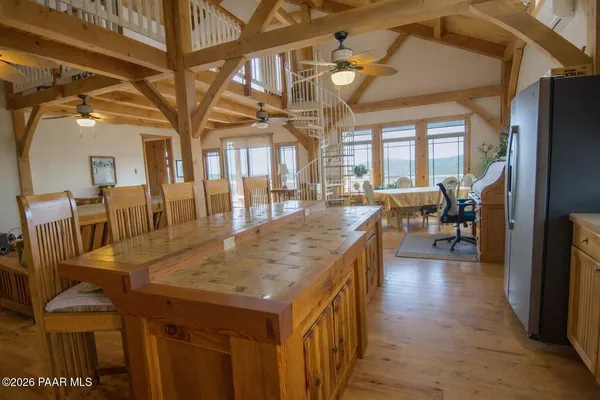 a kitchen with stainless steel appliances kitchen island granite countertop a refrigerator and a stove top oven