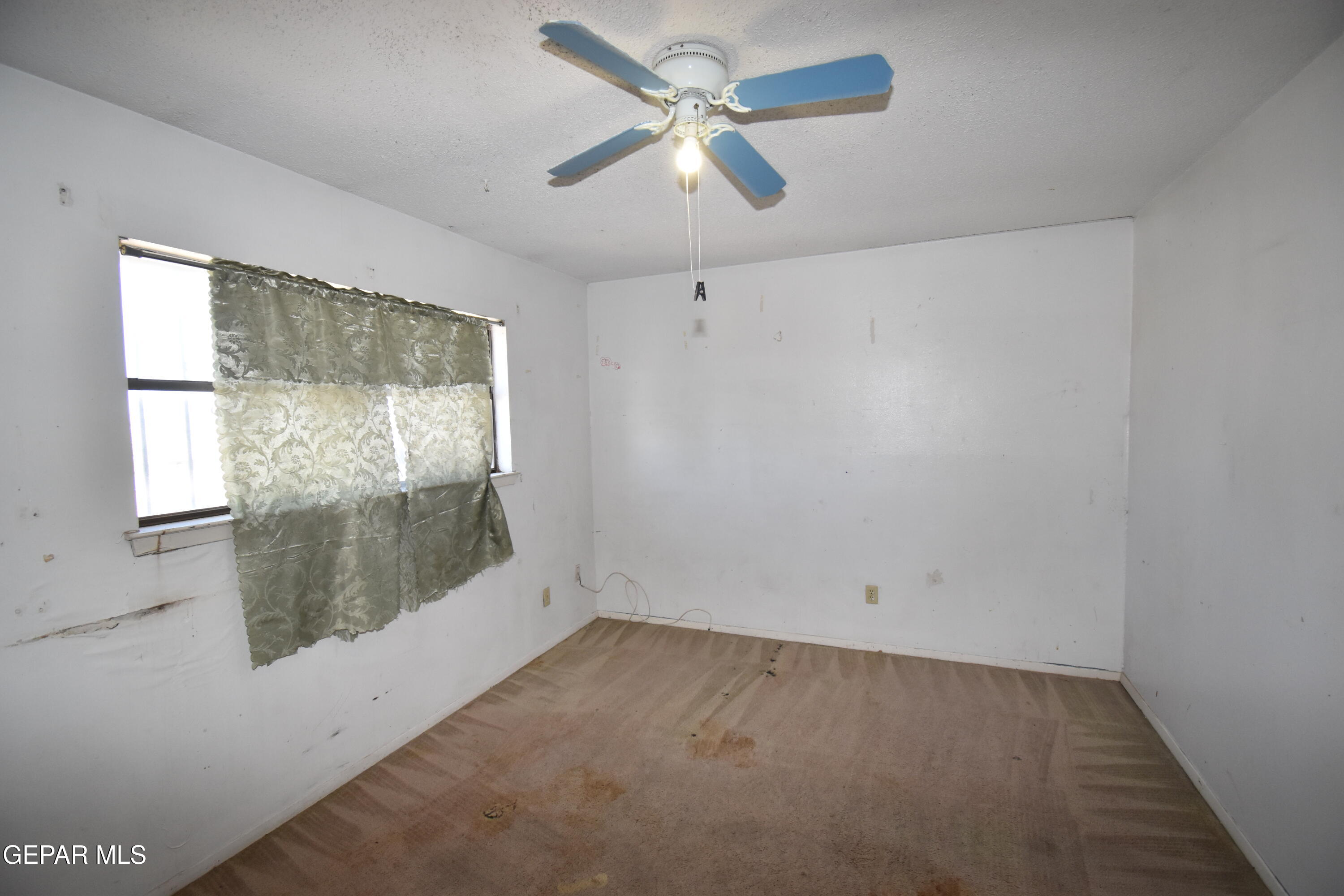 182 Prado Road El Paso, TX 79907 - Photo 15 of 19 an empty room with a window and a ceiling fan