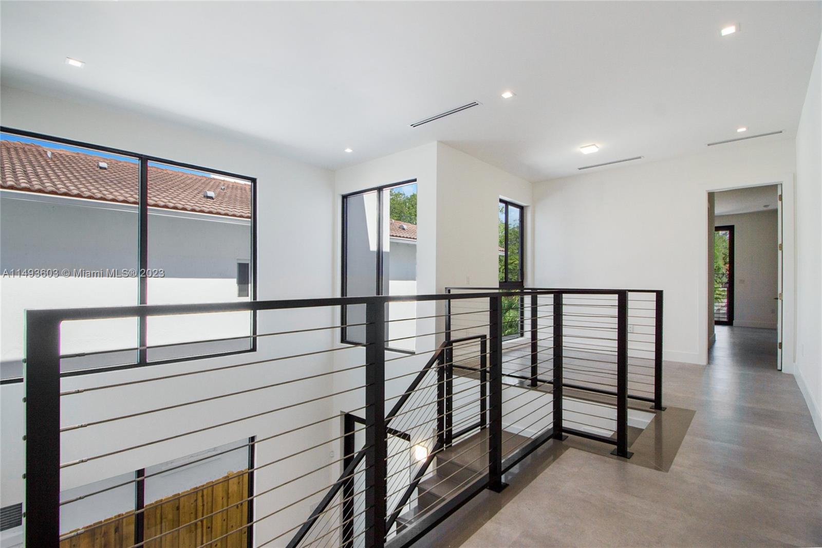 3242 Day Avenue Miami, FL 33133 - Photo 17 of 35 a view of staircase with lots of frames on wall