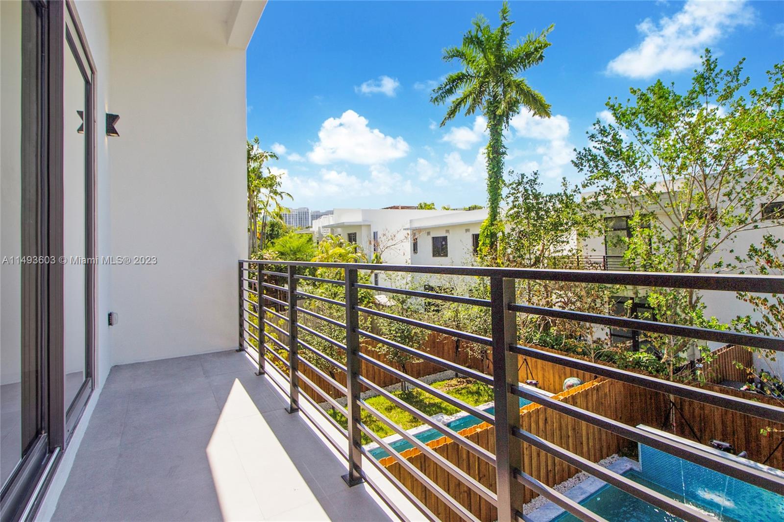 3242 Day Avenue Miami, FL 33133 - Photo 23 of 35 a view of a balcony with floor to ceiling windows and wooden fence