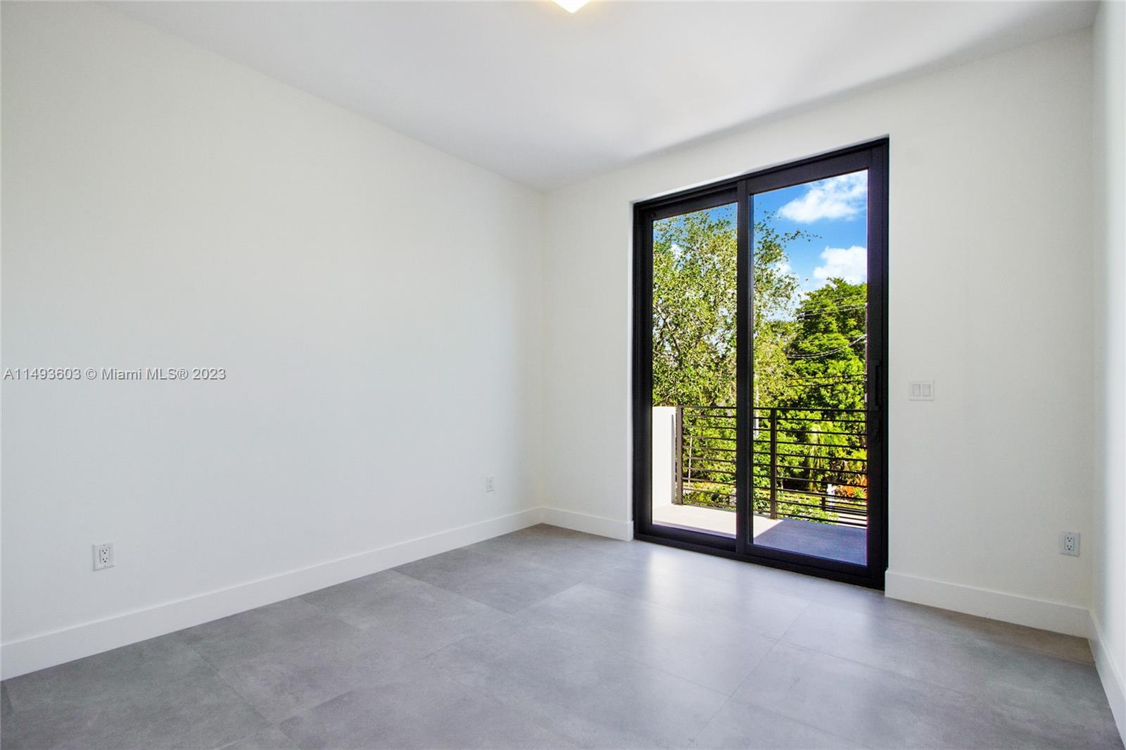 3242 Day Avenue Miami, FL 33133 - Photo 24 of 35 an empty room with wooden floor and windows