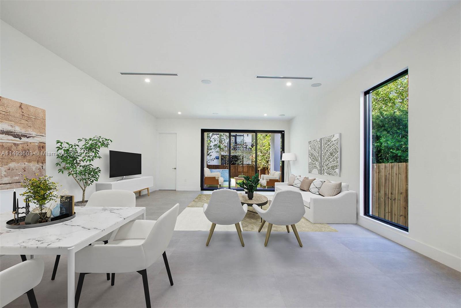 3242 Day Avenue Miami, FL 33133 - Photo 6 of 35 a living room with furniture a flat screen tv and a large window