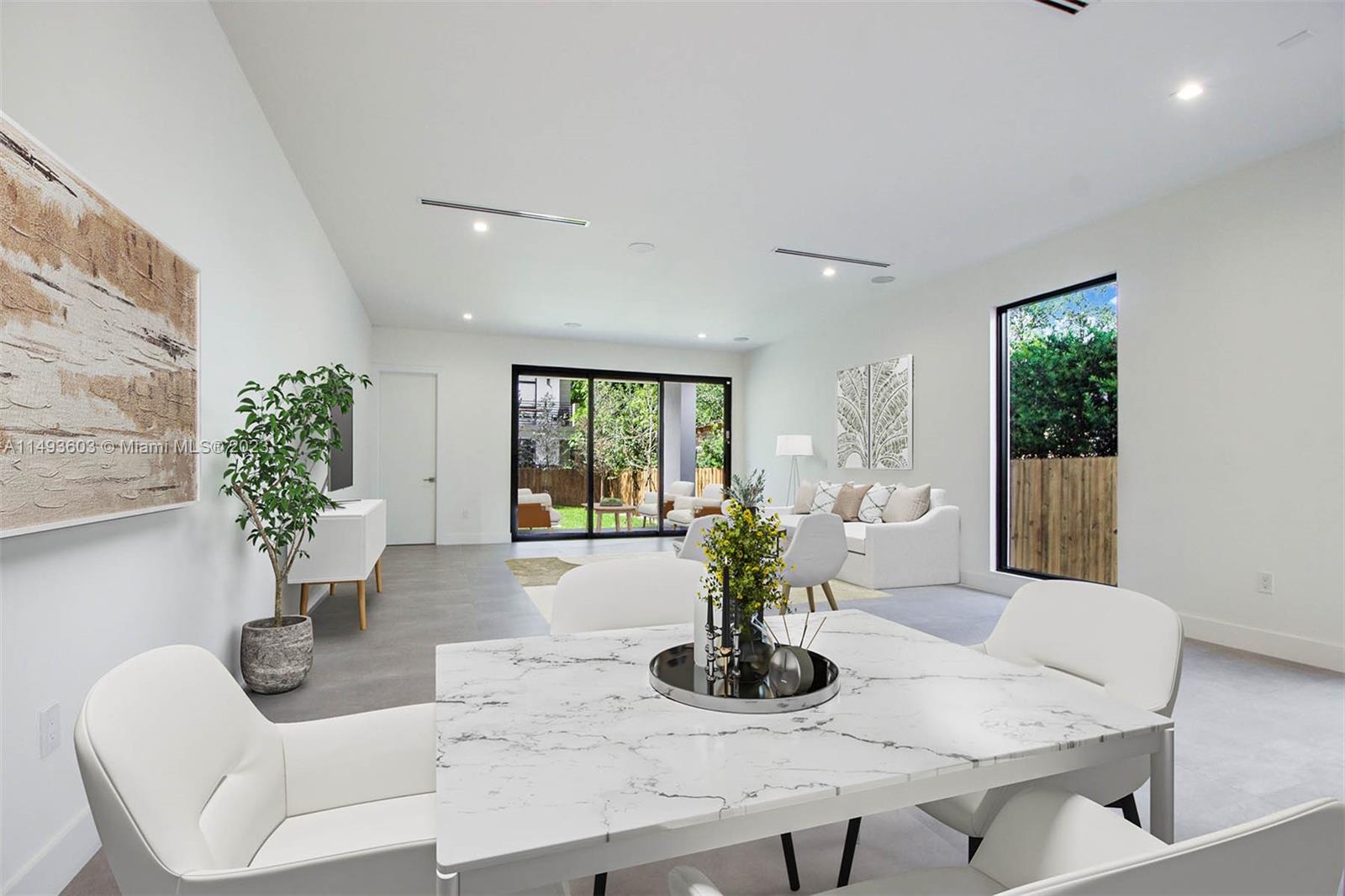3242 Day Avenue Miami, FL 33133 - Photo 7 of 35 a dining room with furniture and potted plants
