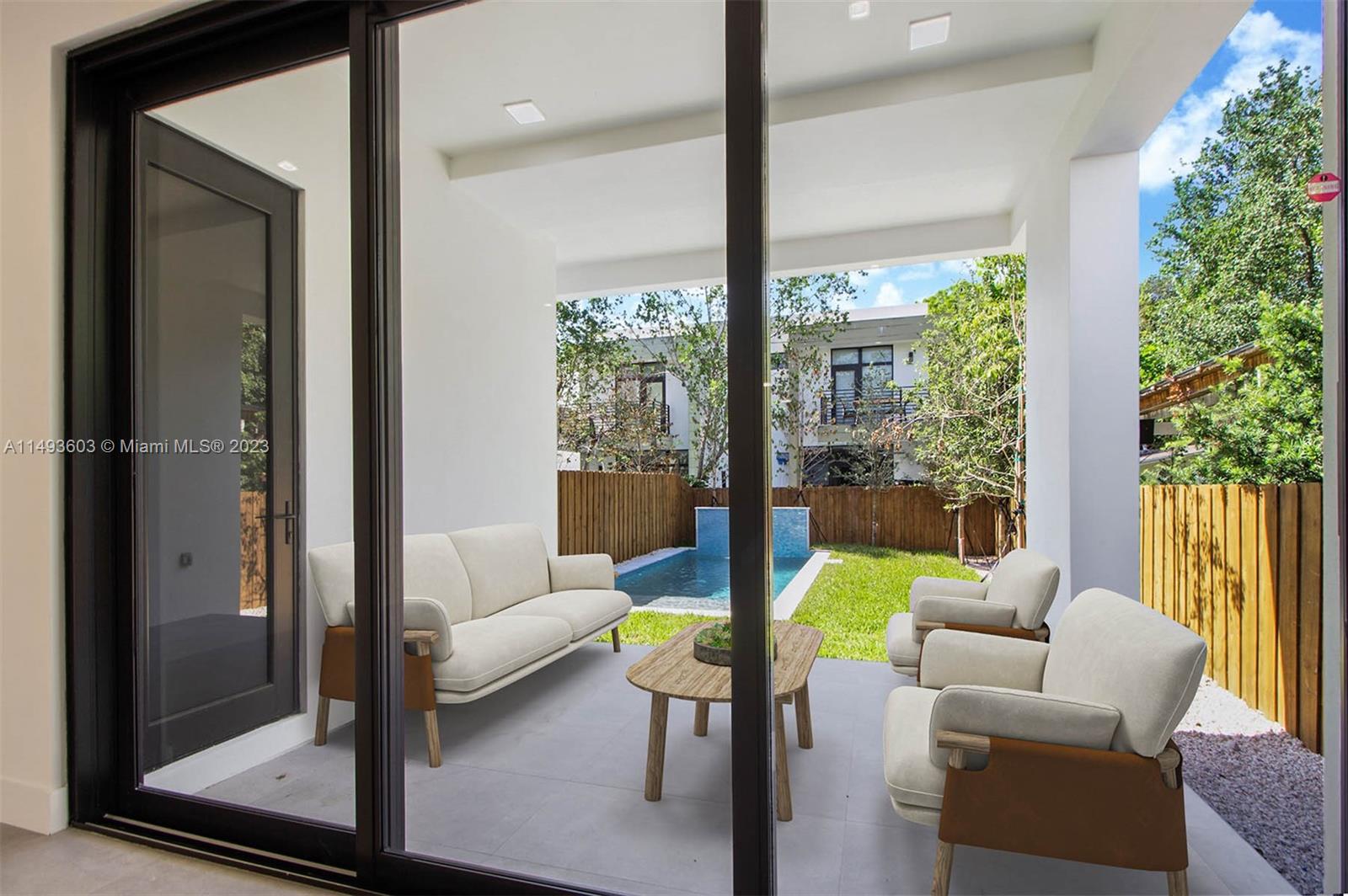 3242 Day Avenue Miami, FL 33133 - Photo 9 of 35 a living room with patio furniture and a garden