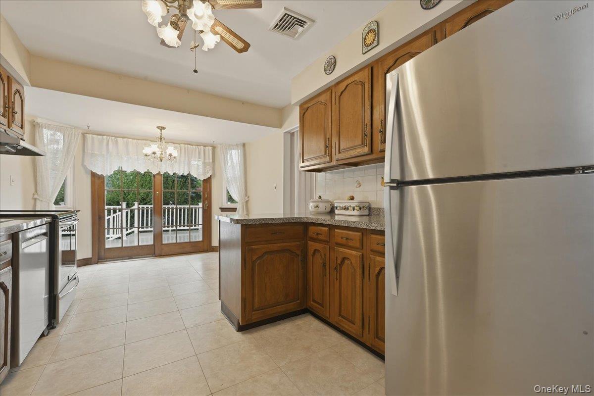 17 Avon Road Farmingdale, NY 11735 - Photo 9 of 46 a kitchen with stainless steel appliances granite countertop a refrigerator a sink and a dishwasher with a large window