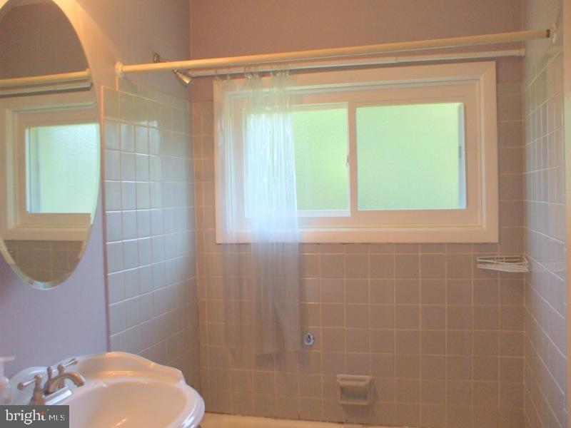 2738 Chapel Road Lancaster, PA 17603 - Photo 12 of 14 a bathroom with a window a toilet and a shower