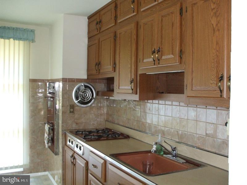2738 Chapel Road Lancaster, PA 17603 - Photo 8 of 14 a kitchen with granite countertop a sink a stove and cabinets