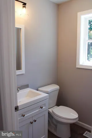 a white toilet sitting next to a bathroom sink