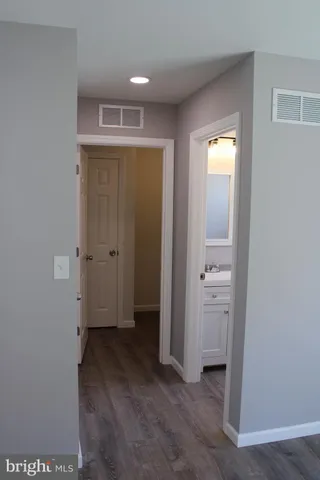 an empty room with closet and a bathroom