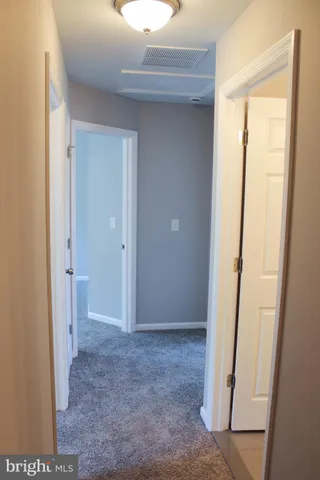a bathroom with a granite countertop toilet a sink a mirror and shower
