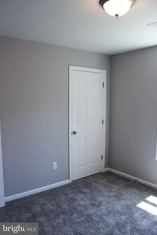 an empty room with closet area