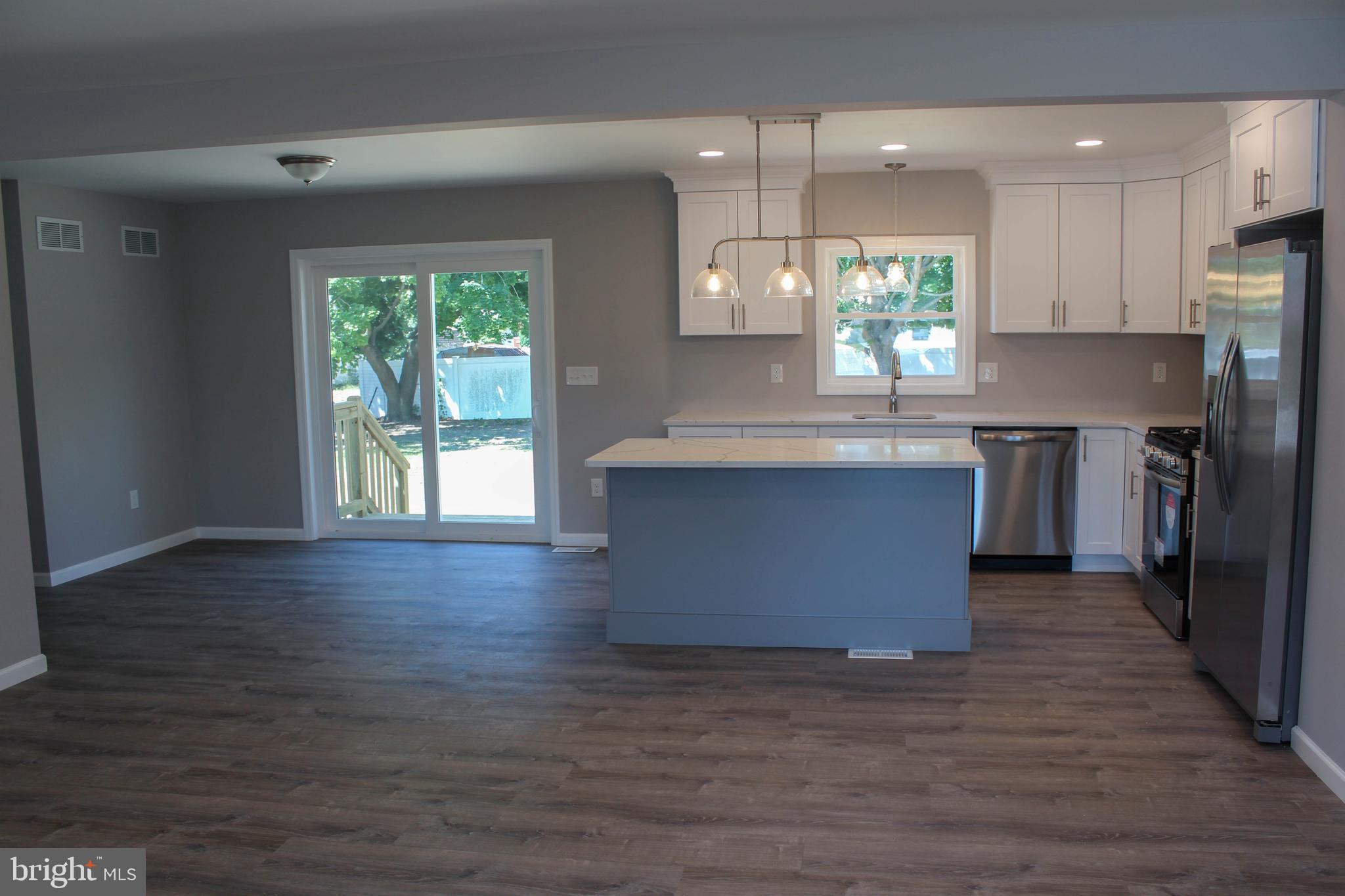 1402 Central Minotola, NJ 08341 - Photo 4 of 33 an open kitchen with wooden floor and stainless steel appliances