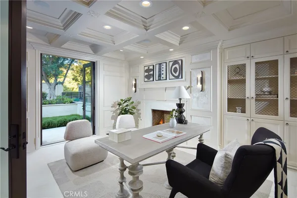 a living room with fireplace furniture and a large window