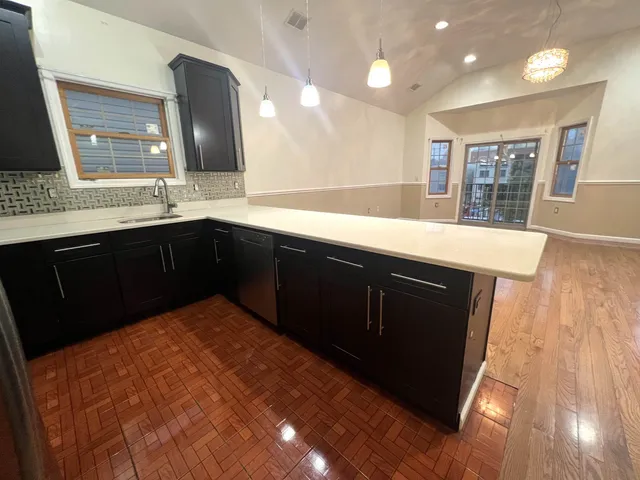 a kitchen with a sink and a mirror