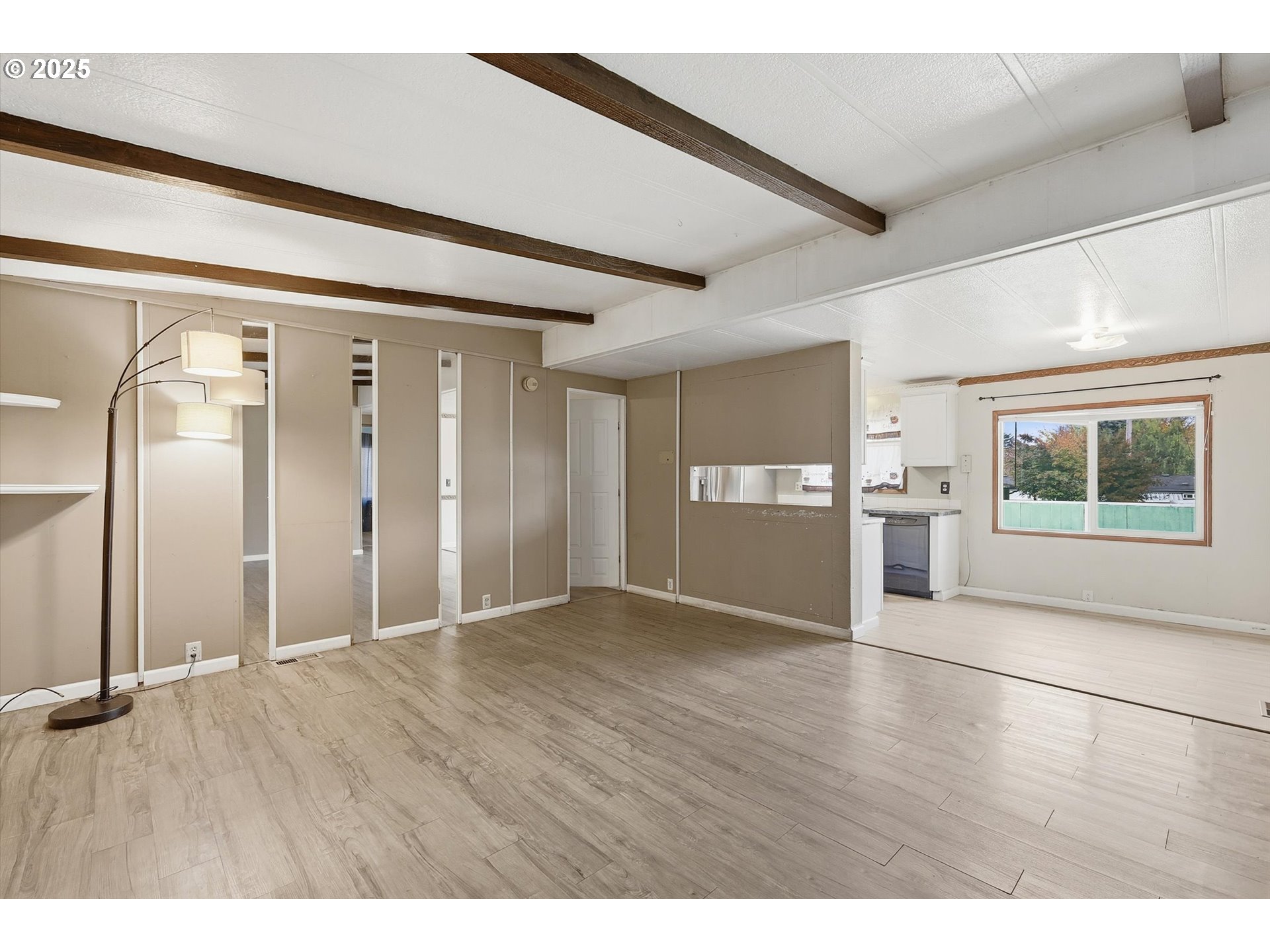23200 Northeast Sandy Boulevard, Unit 77 Troutdale, OR 97060 - Photo 12 of 43 a view of an empty room with window and wooden floor