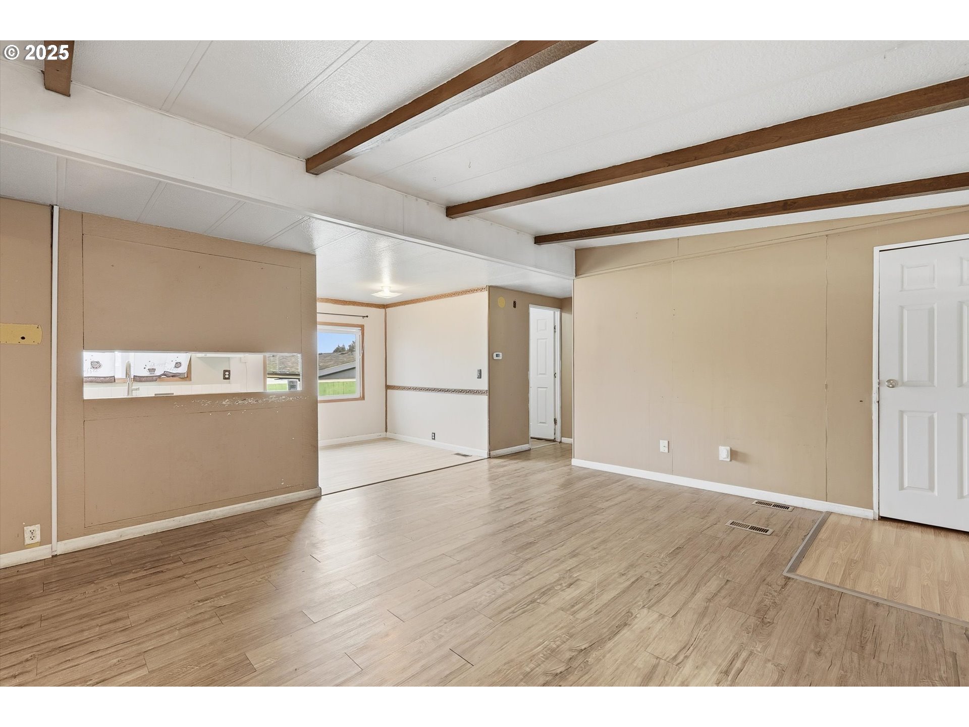 23200 Northeast Sandy Boulevard, Unit 77 Troutdale, OR 97060 - Photo 13 of 43 a view of an empty room with wooden floor
