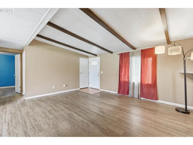 a view of a room with wooden floor