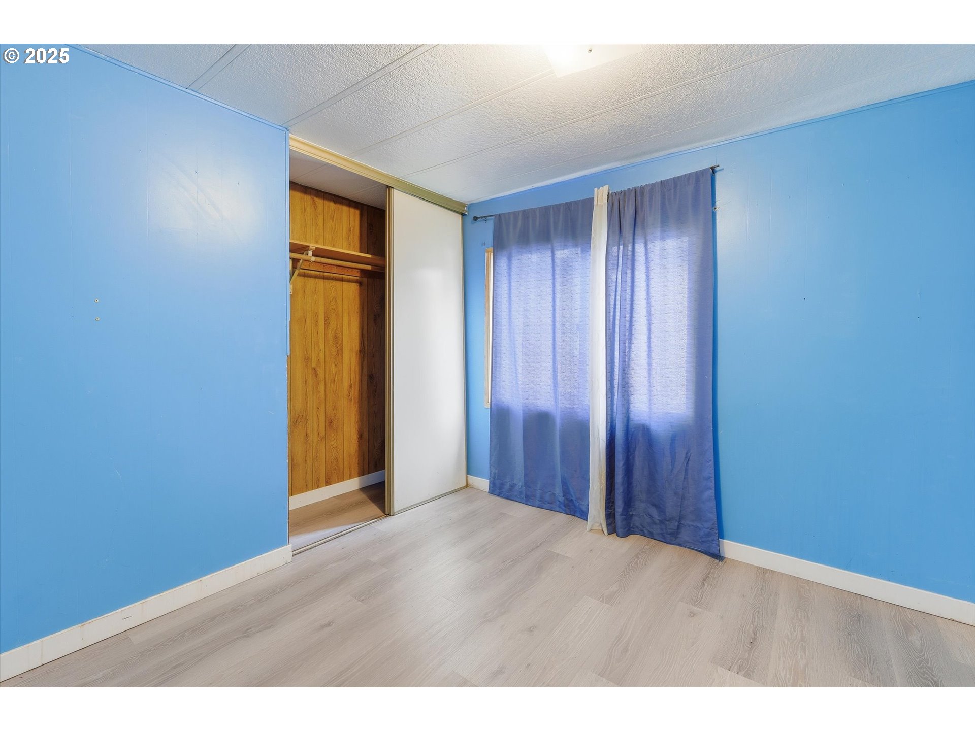 23200 Northeast Sandy Boulevard, Unit 77 Troutdale, OR 97060 - Photo 28 of 43 a view of an empty room with closet and wooden floor
